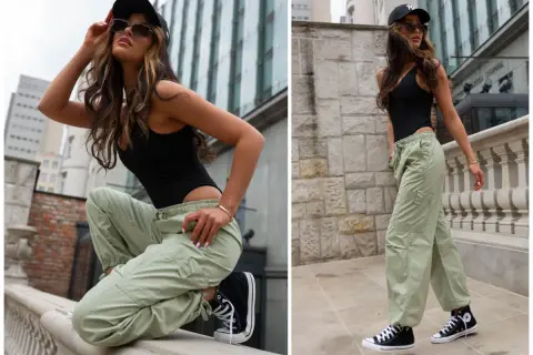 Kobieta w czarnym body i zielonych bojówkach, idealne jakie buty do bojówek? Czarne trampki Converse.